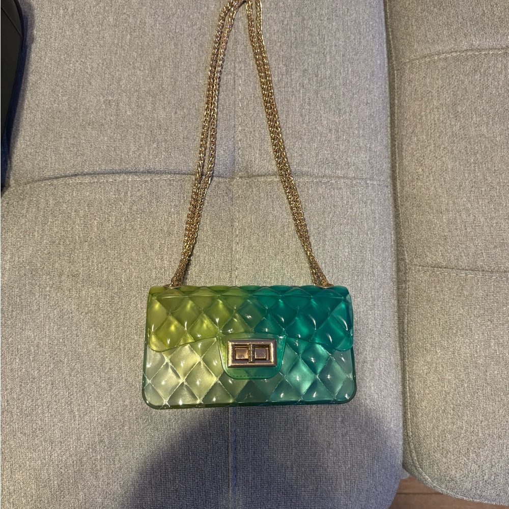 Mini transparent green and blue bag with gold chain.